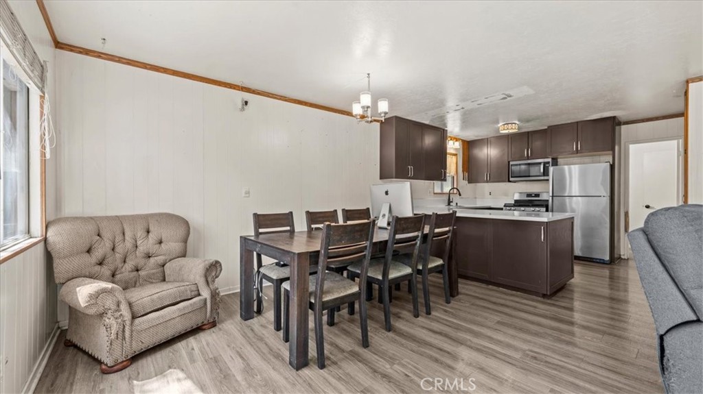 31347 Circle View Drive Running Springs, CA 92382 - Photo 10 of 48 a living room with couches chairs and kitchen view with wooden floor