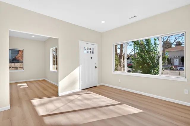 wooden floor in an empty room with a window