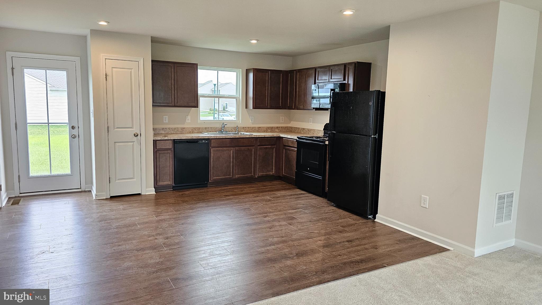 11 Orchard Road Seaford, DE 19973 - Photo 22 of 76 a kitchen with granite countertop a refrigerator and a stove top oven
