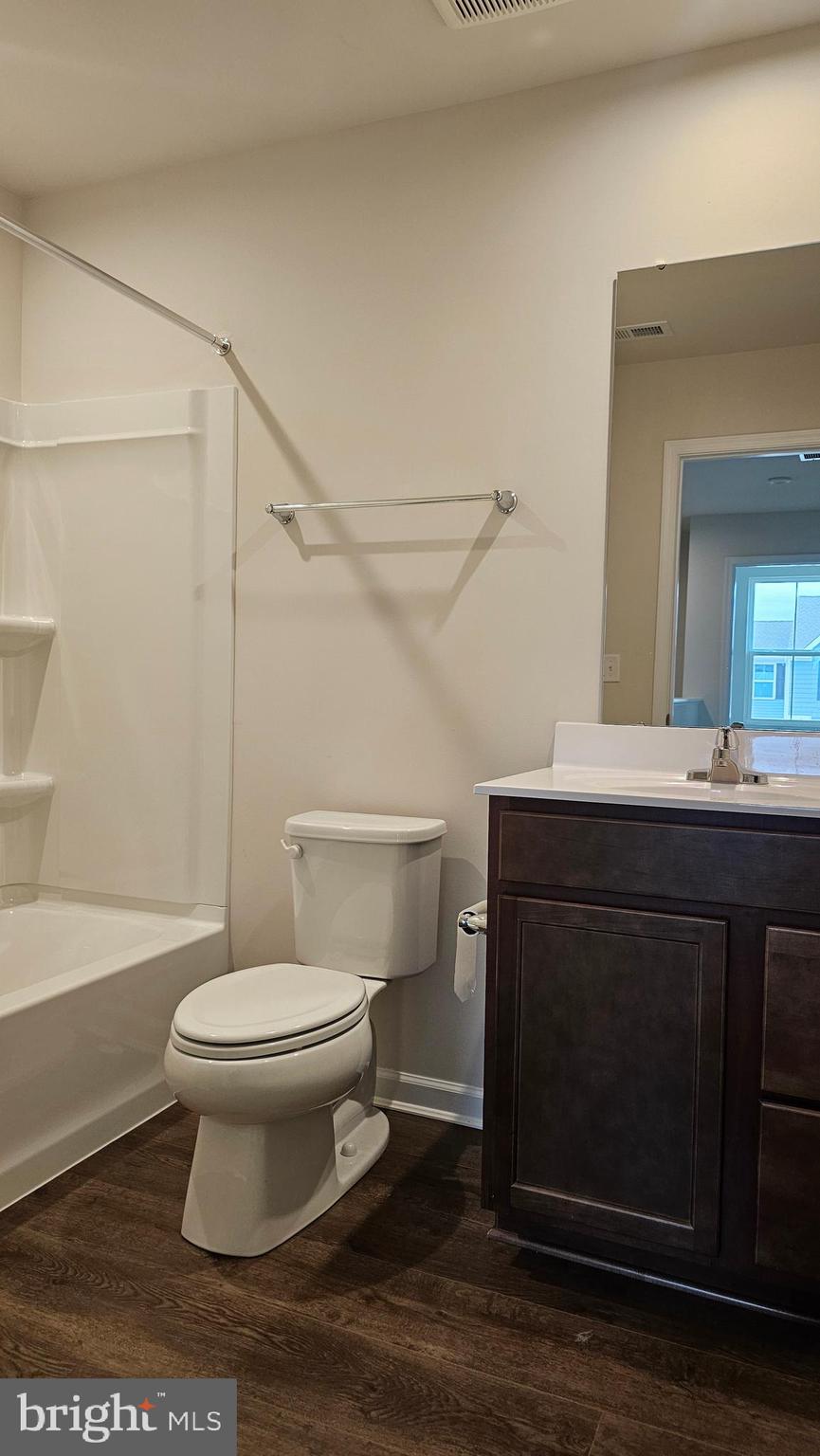 11 Orchard Road Seaford, DE 19973 - Photo 45 of 76 a bathroom with a sink toilet a mirror and shower