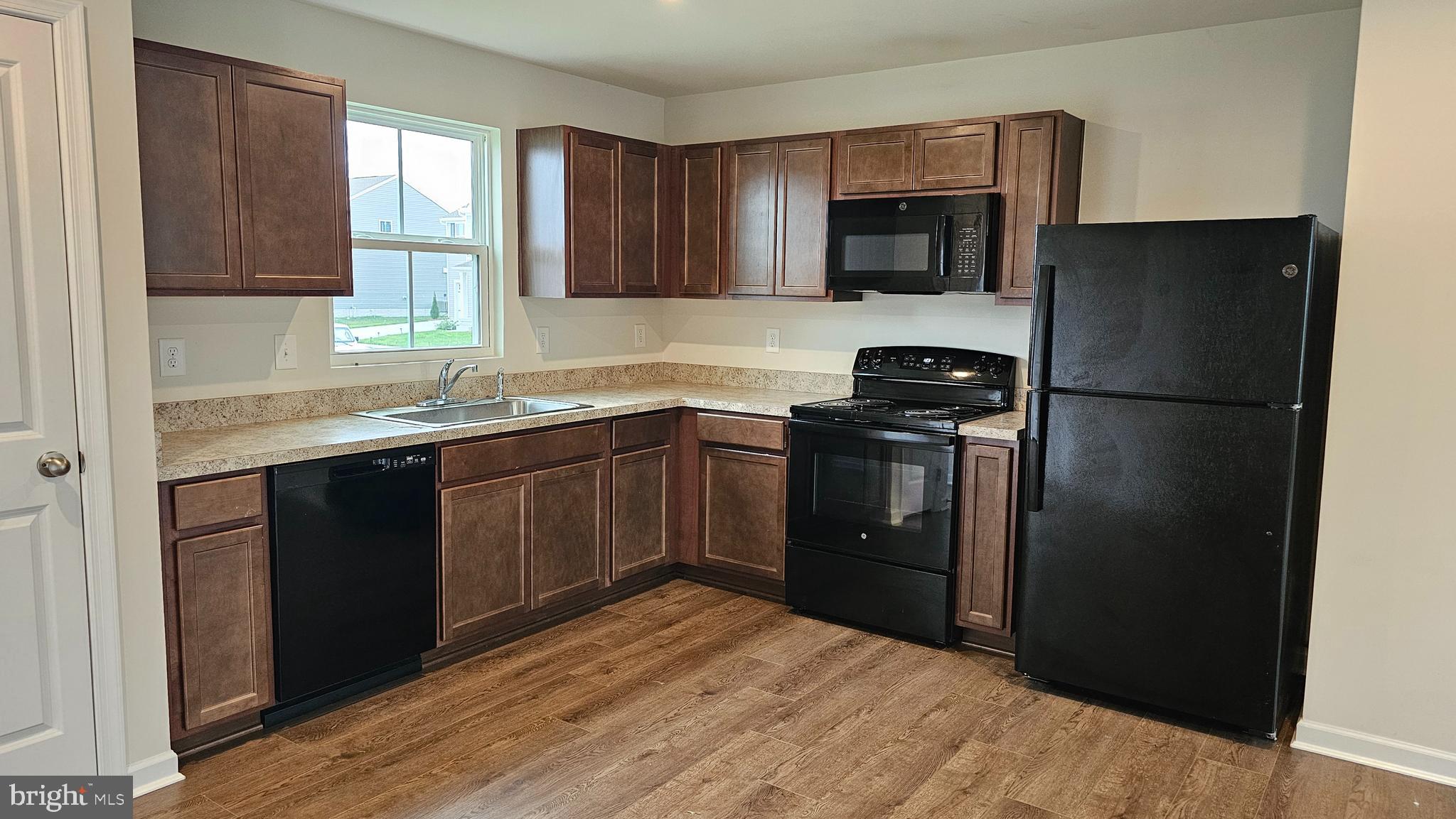 11 Orchard Road Seaford, DE 19973 - Photo 51 of 76 a kitchen with a sink a refrigerator and cabinets