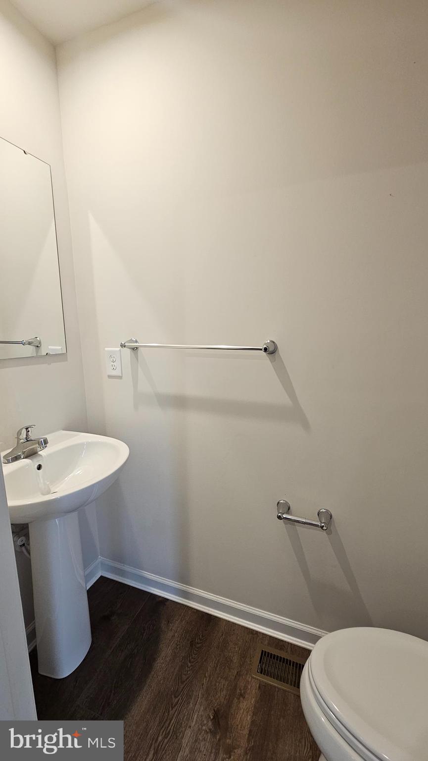 11 Orchard Road Seaford, DE 19973 - Photo 54 of 76 a bathroom with a sink a toilet and vanity