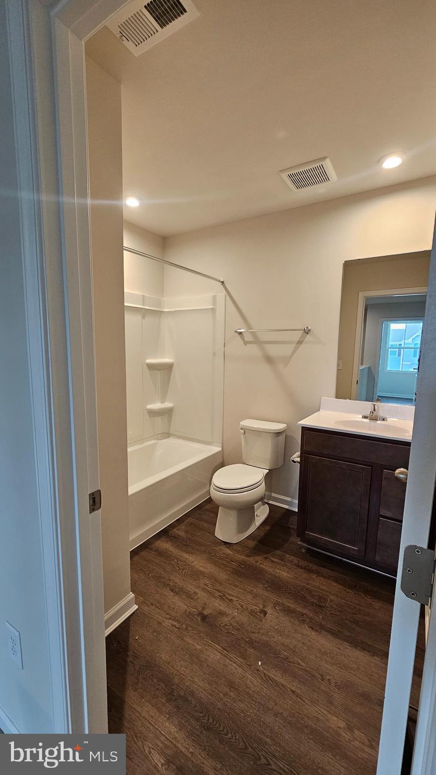 11 Orchard Road Seaford, DE 19973 - Photo 71 of 76 a bathroom with a toilet a sink and mirror