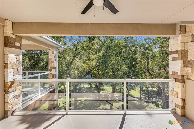 a view of a balcony with lake view and a floor to ceiling window