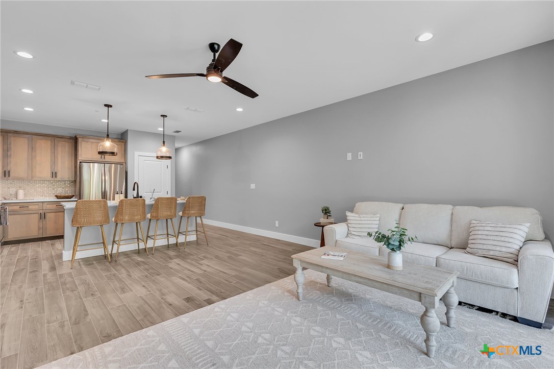 540 River Run, Unit 314 New Braunfels, TX 78132 - Photo 3 of 15 a living room with furniture and a view of kitchen