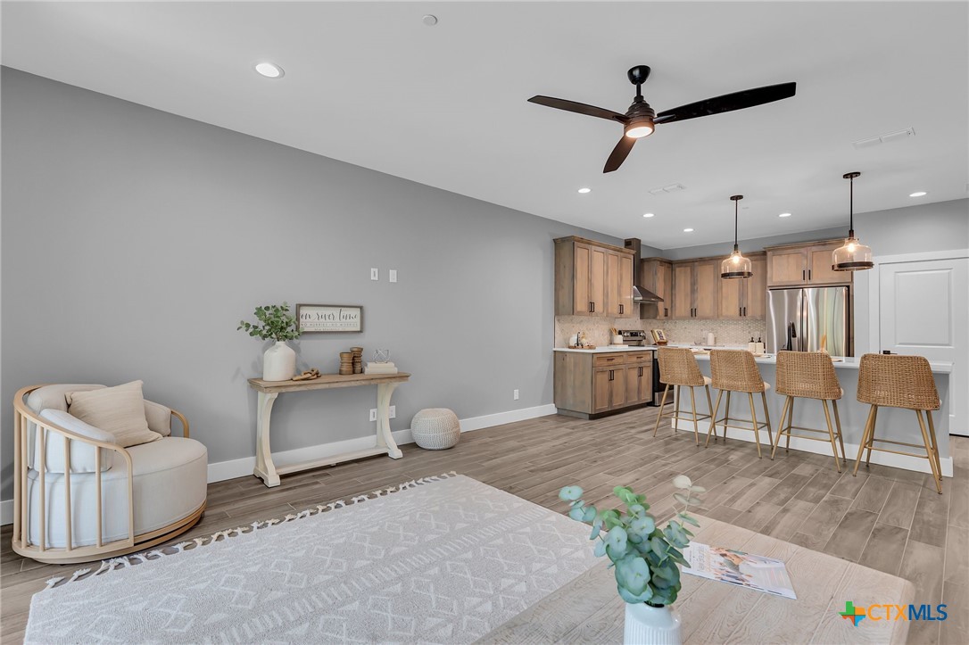 540 River Run, Unit 314 New Braunfels, TX 78132 - Photo 4 of 15 a living room with furniture and kitchen view