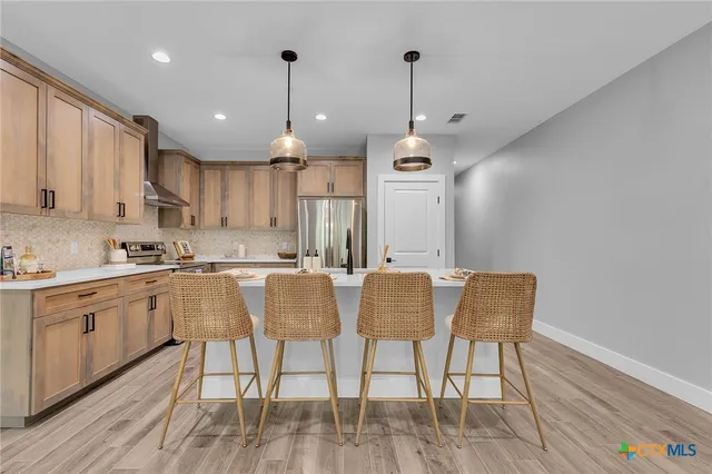 a large kitchen with a table and chairs