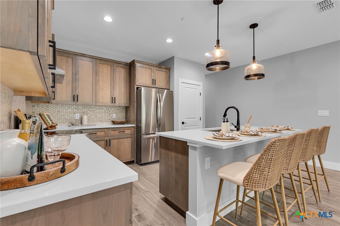 540 River Run, Unit 314 New Braunfels, TX 78132 - Photo 8 of 15 a kitchen with stainless steel appliances granite countertop a sink a stove and refrigerator