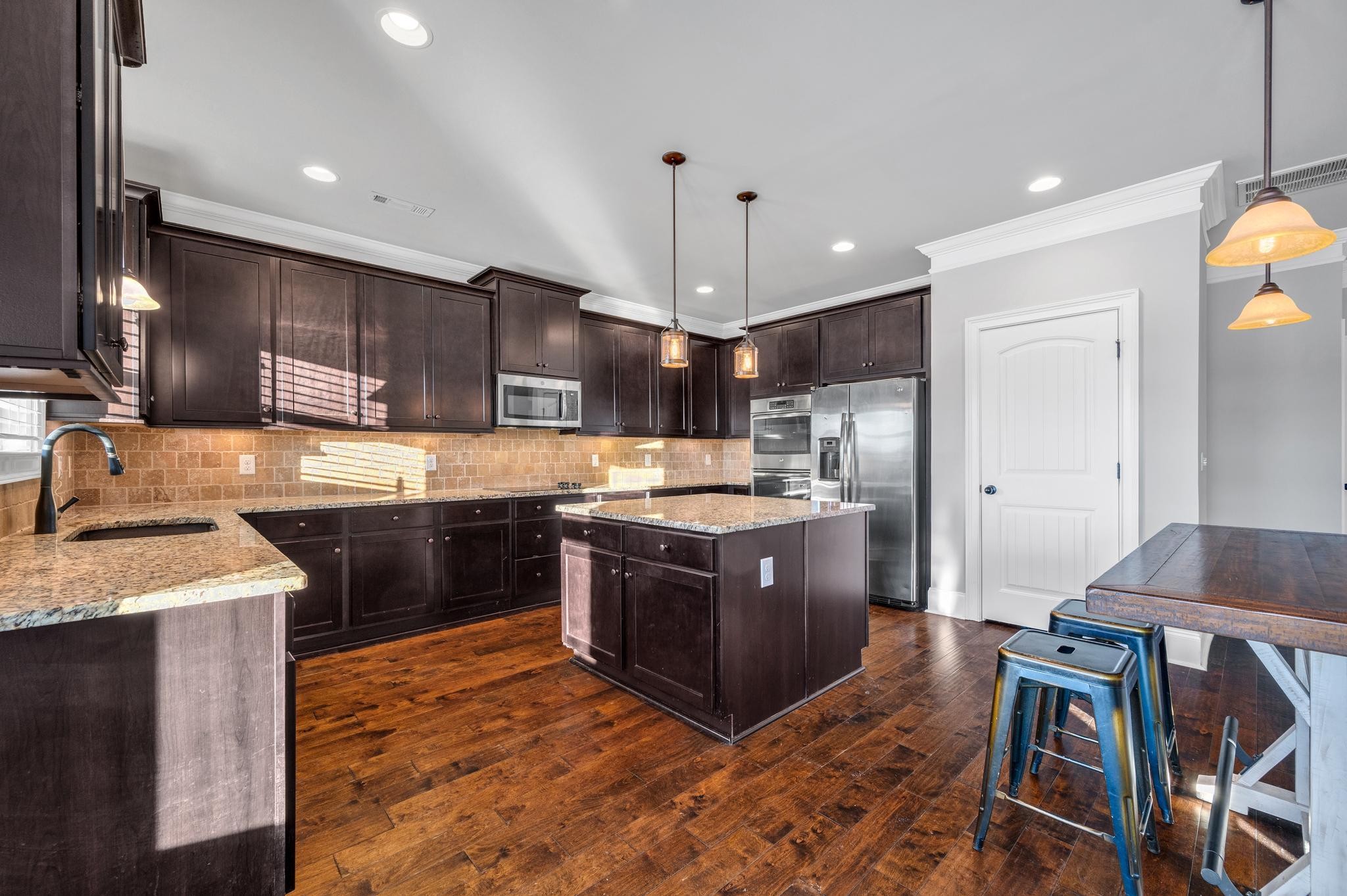 236 McClaran Place Murfreesboro, TN 37129 - Photo 13 of 48 a large kitchen with stainless steel appliances granite countertop a stove a sink dishwasher a microwave oven and a refrigerator with wooden floor