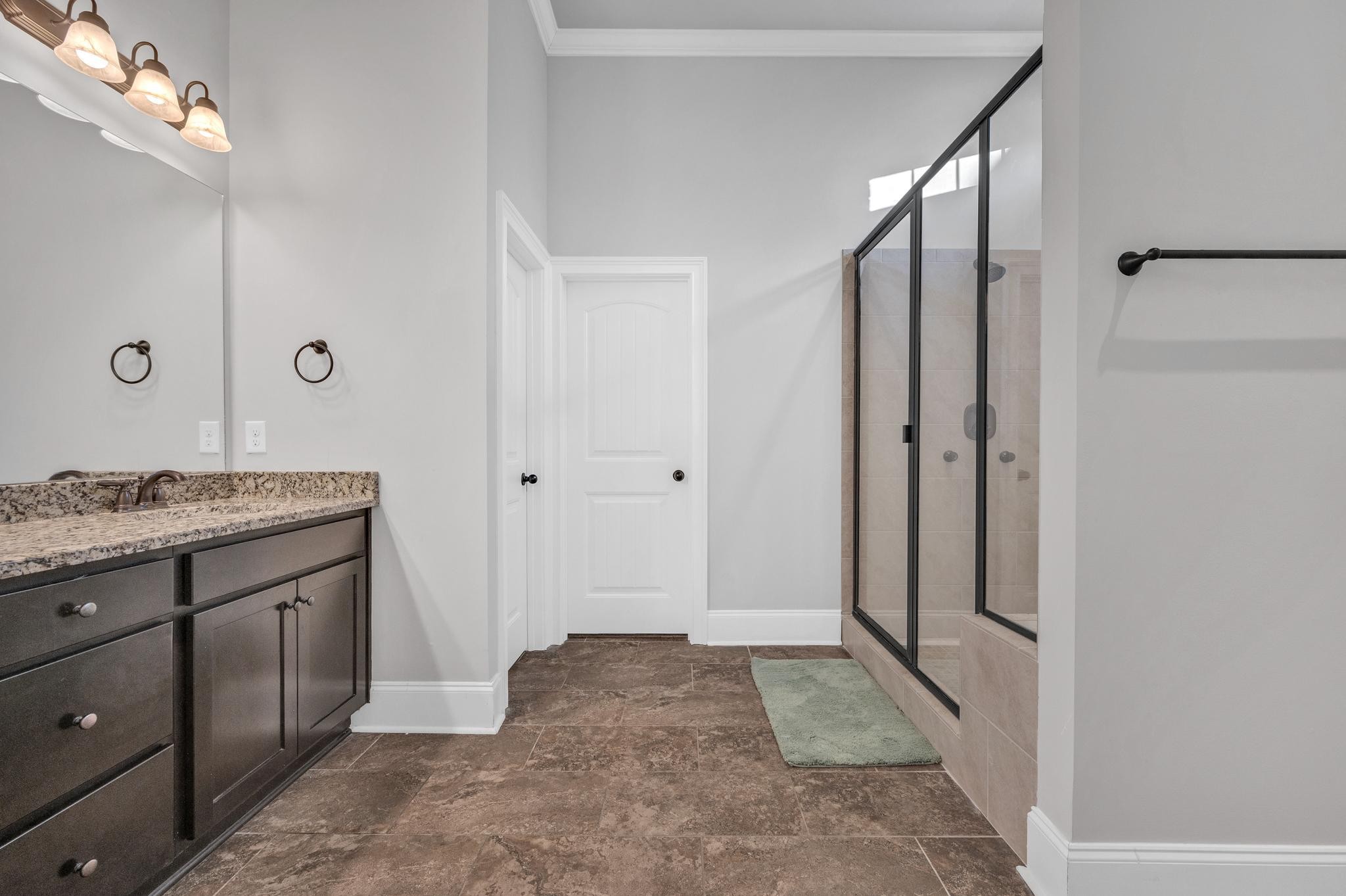 236 McClaran Place Murfreesboro, TN 37129 - Photo 25 of 48 a bathroom with a granite countertop sink a mirror and a shower