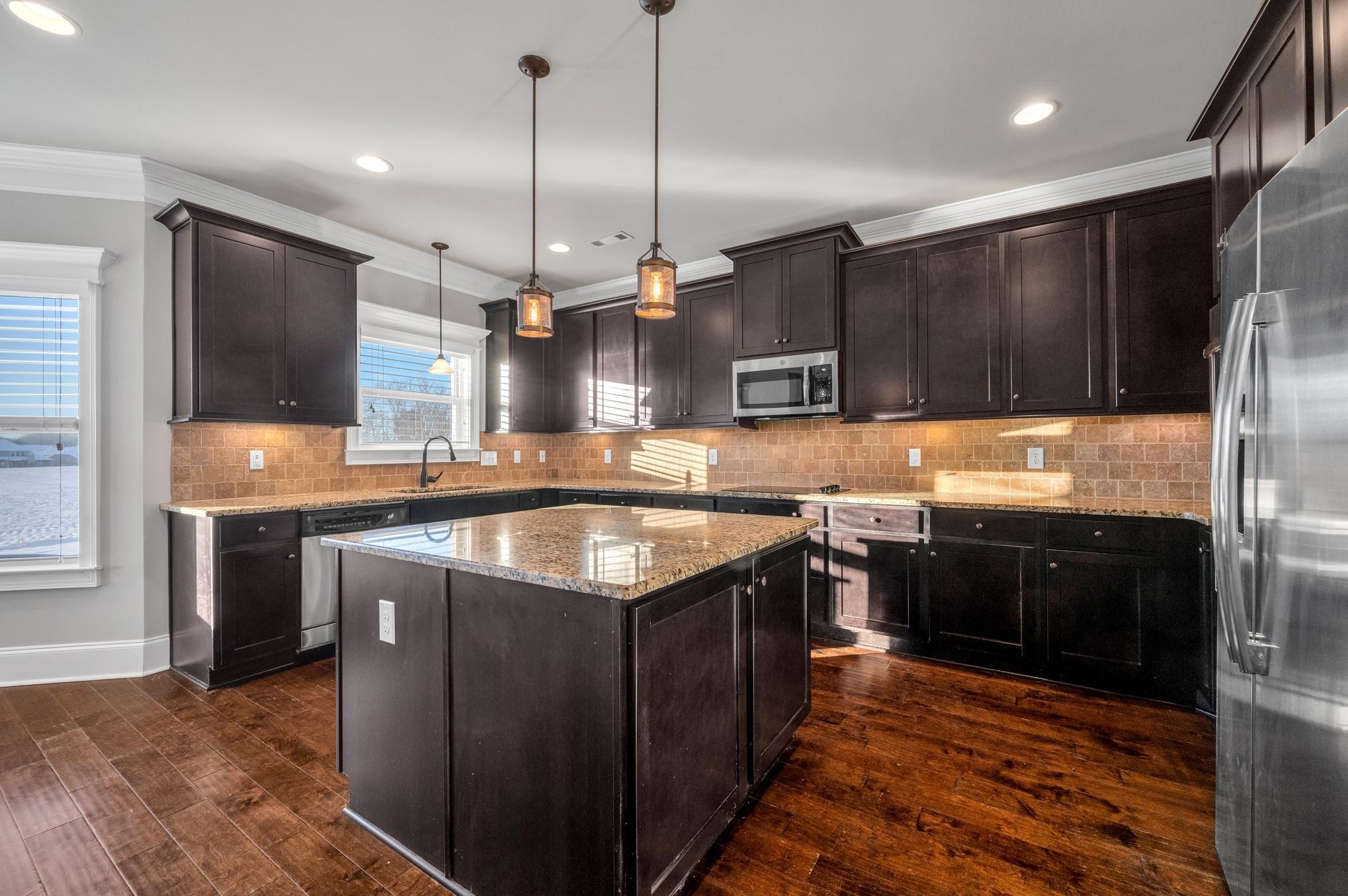 236 McClaran Place Murfreesboro, TN 37129 - Photo 9 of 48 a kitchen with stainless steel appliances granite countertop a sink a stove and a refrigerator