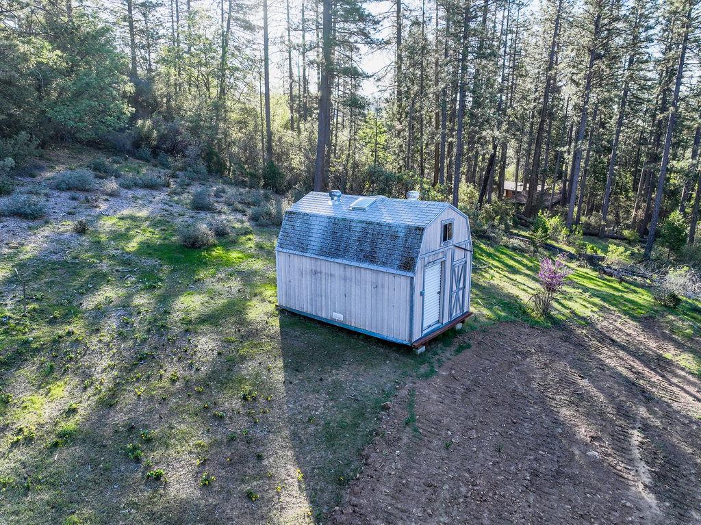 13279 Thoroughbred Loop Grass Valley, CA 95949 - Photo 7 of 33 a view of a backyard with a small cabin and wooden fence