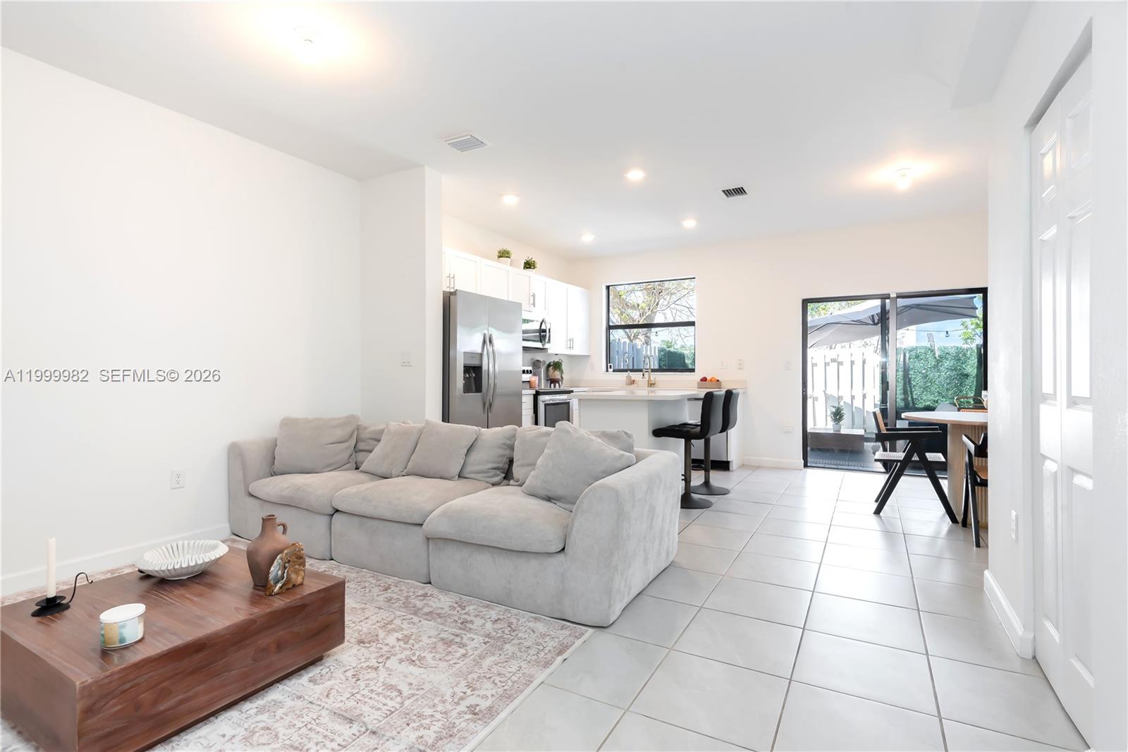 9949 Southwest 228th Terrace Miami, FL 33190 - Photo 12 of 40 a living room with furniture and a dining table