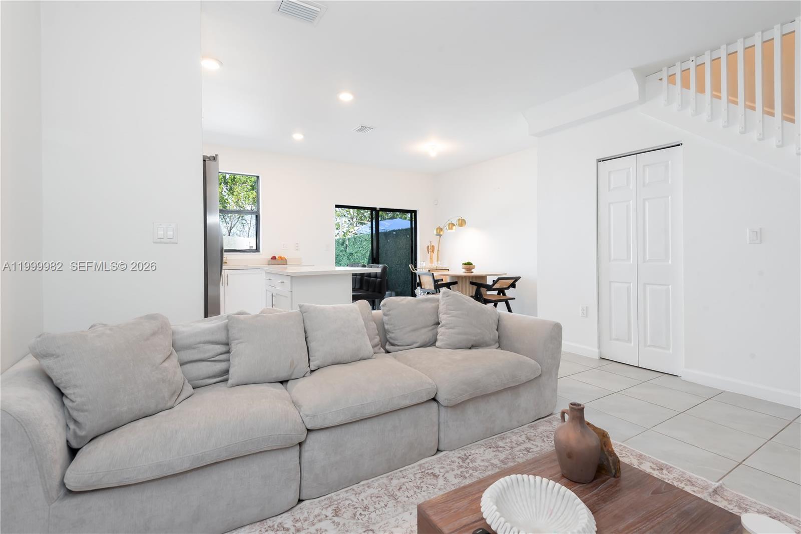 9949 Southwest 228th Terrace Miami, FL 33190 - Photo 14 of 40 a living room with furniture and a large window