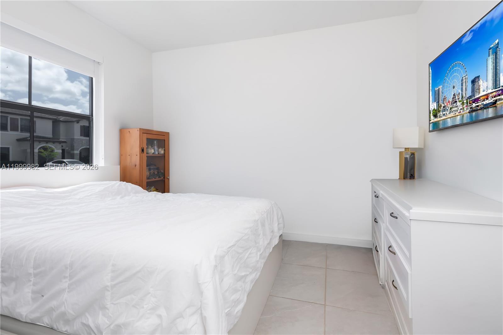 9949 Southwest 228th Terrace Miami, FL 33190 - Photo 16 of 40 a bedroom with a bed and a cabinets