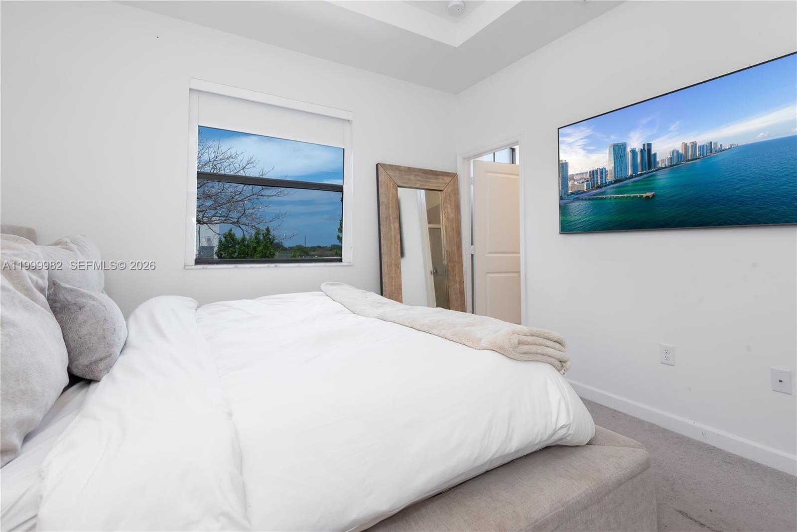 9949 Southwest 228th Terrace Miami, FL 33190 - Photo 19 of 40 a bedroom with a bed and a flat screen tv
