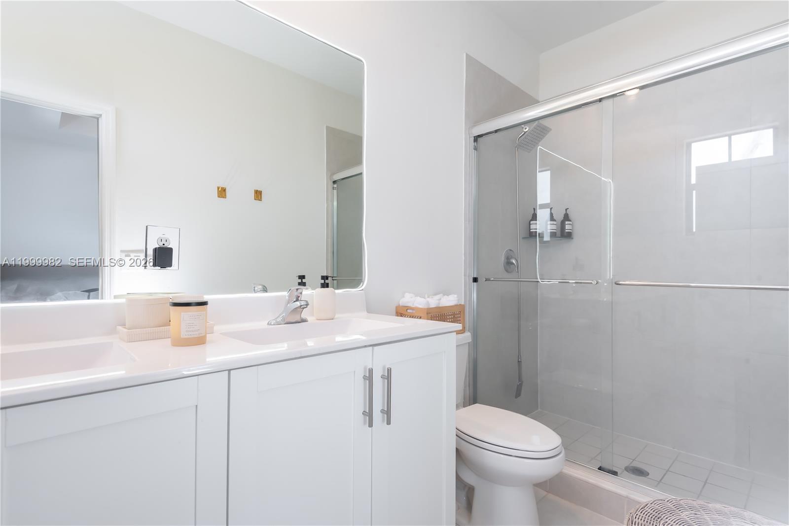 9949 Southwest 228th Terrace Miami, FL 33190 - Photo 20 of 40 a bathroom with a sink toilet and shower
