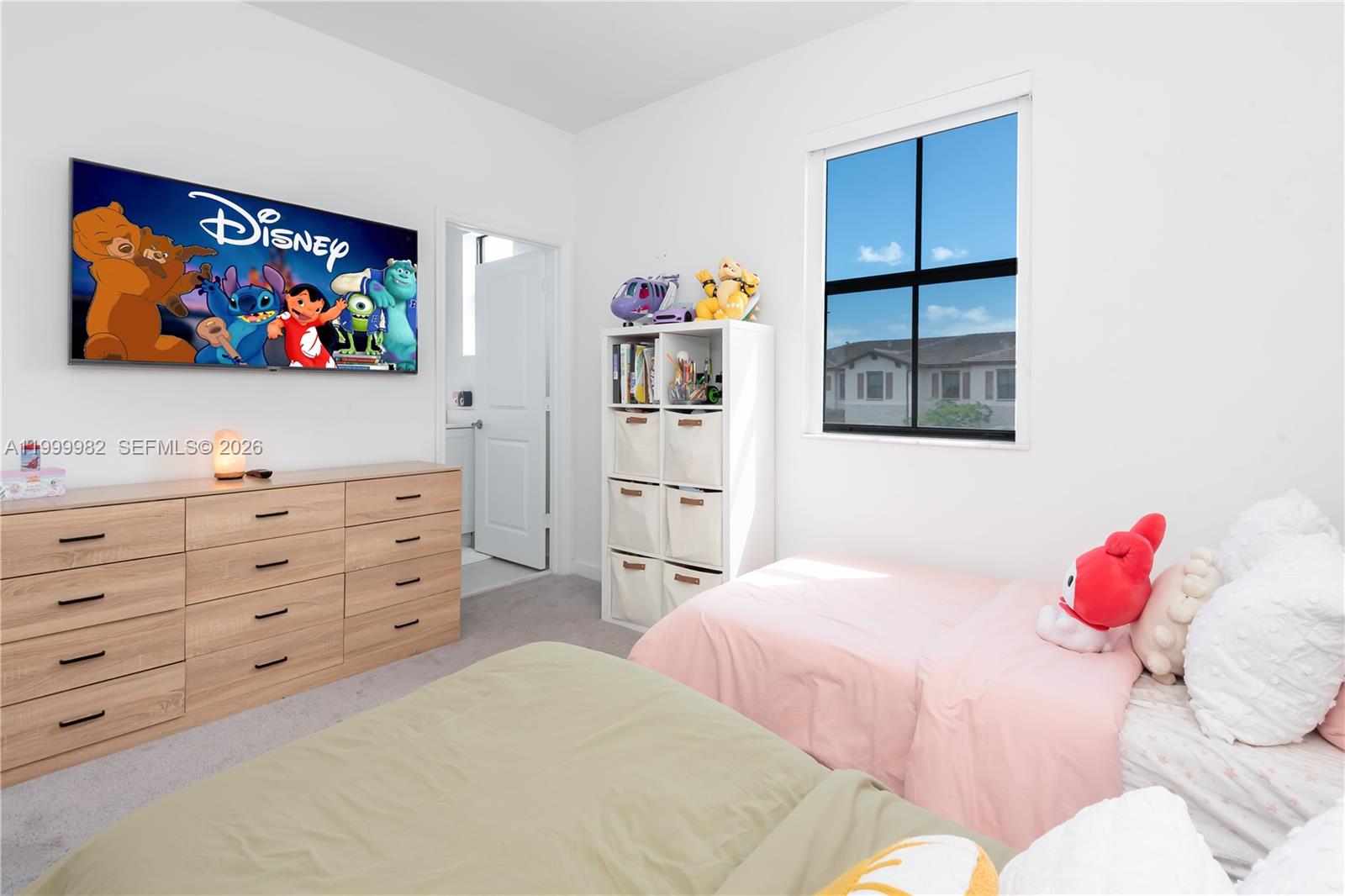 9949 Southwest 228th Terrace Miami, FL 33190 - Photo 23 of 40 a bedroom with a bed and a flat screen tv