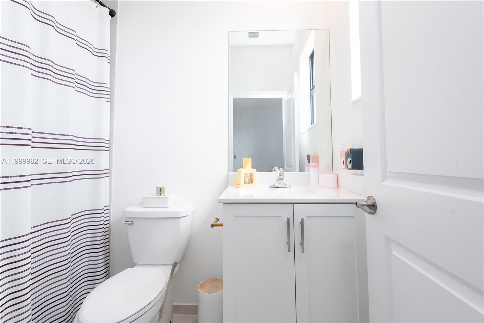 9949 Southwest 228th Terrace Miami, FL 33190 - Photo 26 of 40 a bathroom with a sink toilet and mirror