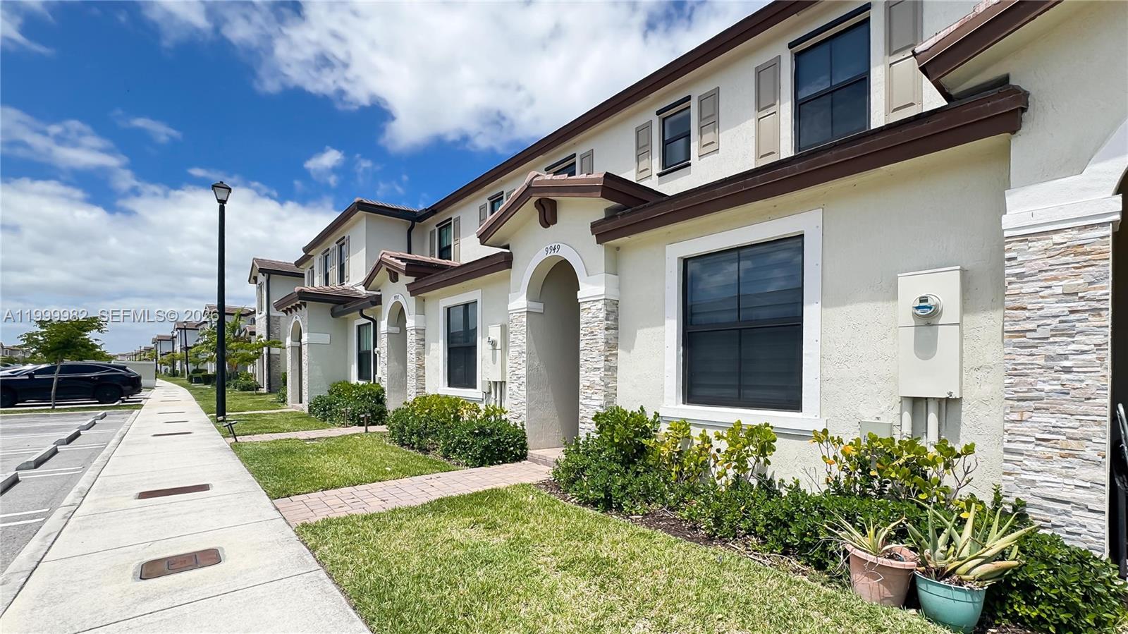 9949 Southwest 228th Terrace Miami, FL 33190 - Photo 30 of 40 a front view of a house with garden
