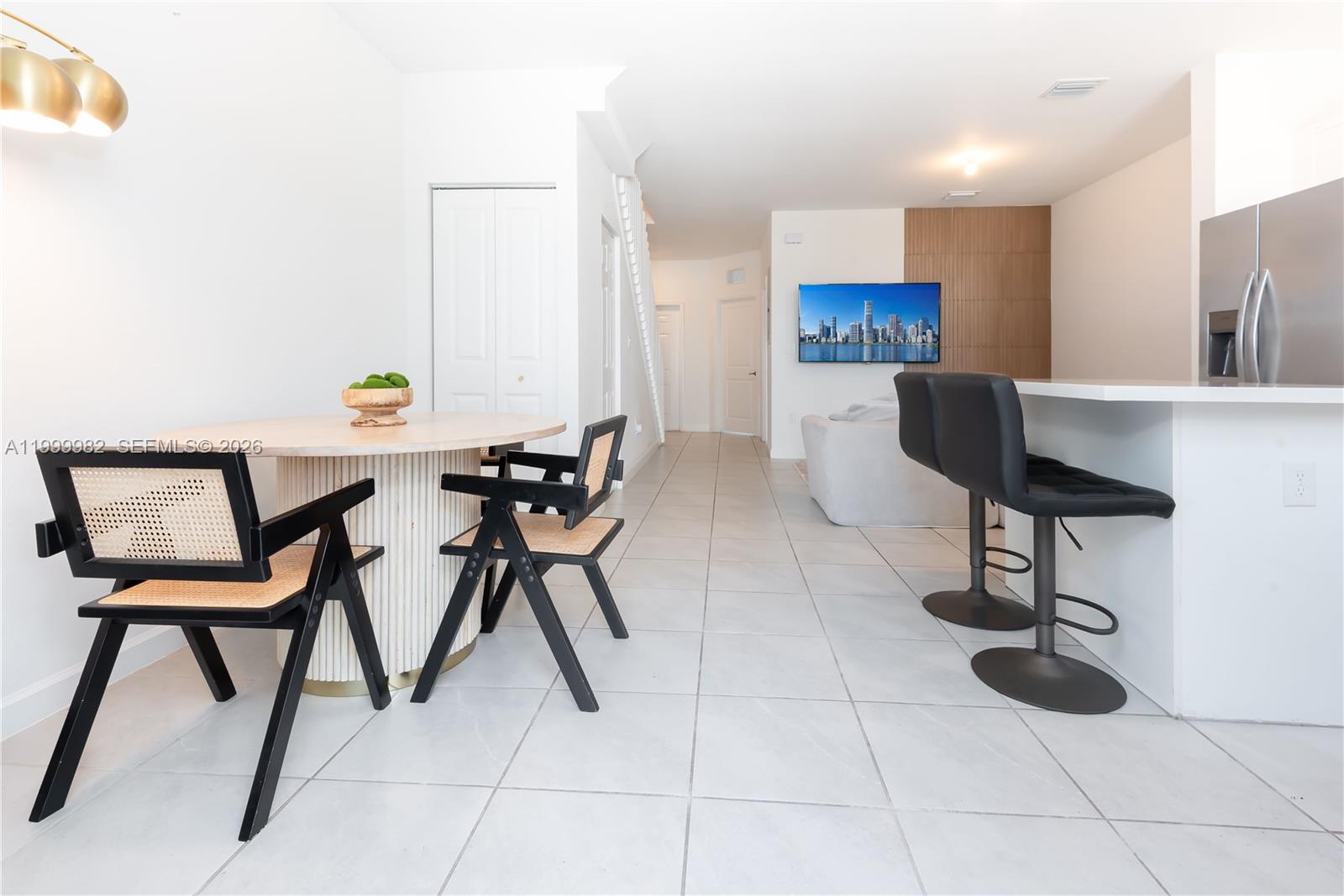 9949 Southwest 228th Terrace Miami, FL 33190 - Photo 5 of 40 a view of a kitchen with furniture and a refrigerator