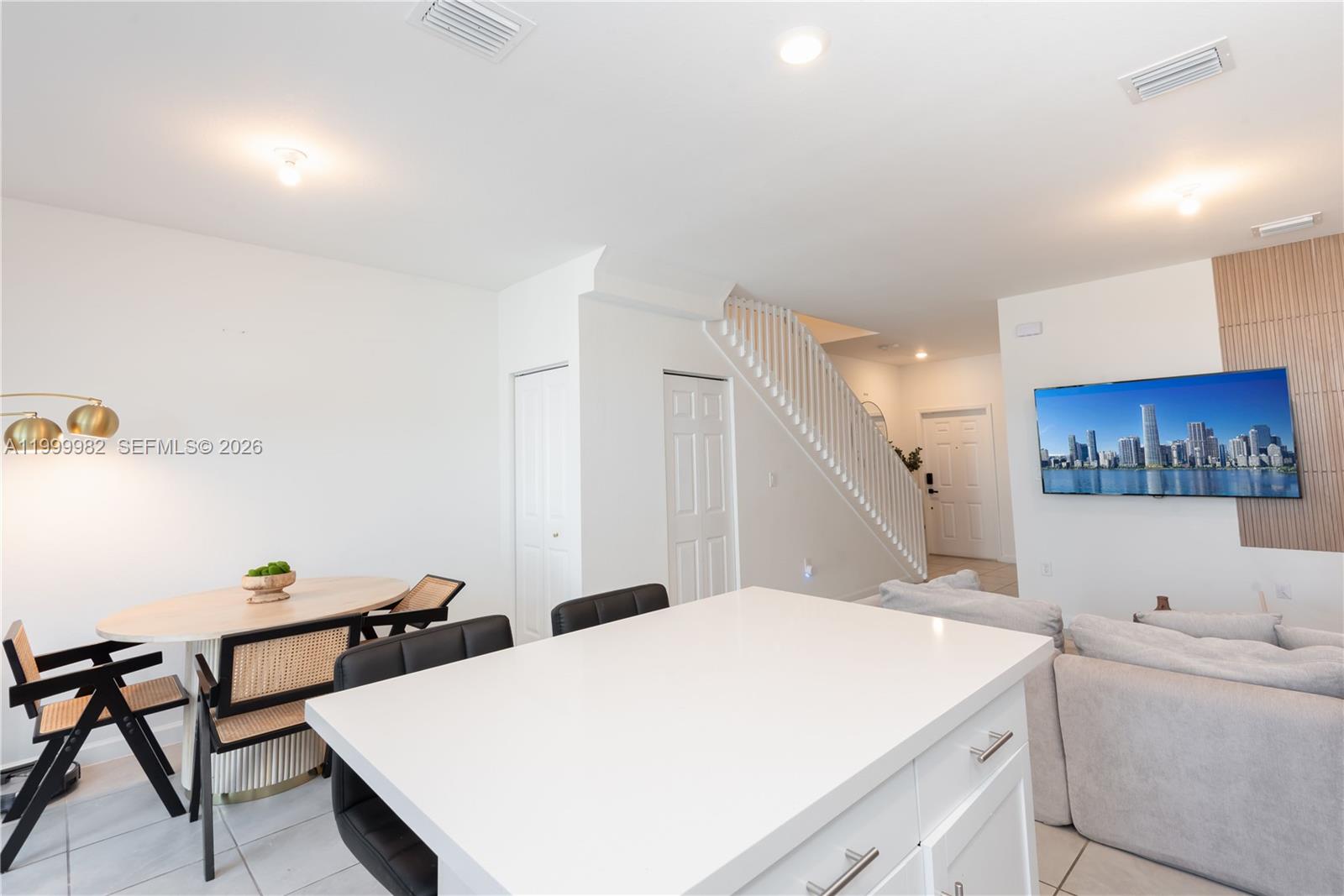 9949 Southwest 228th Terrace Miami, FL 33190 - Photo 8 of 40 a room with a table chairs and a couch