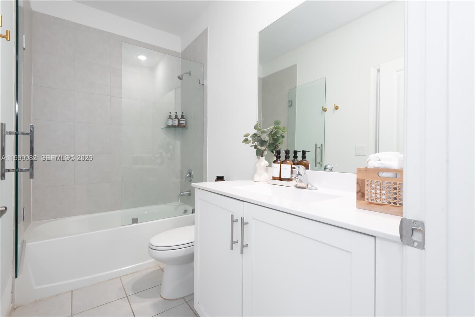 9949 Southwest 228th Terrace Miami, FL 33190 - Photo 9 of 40 a bathroom with a sink a toilet and shower