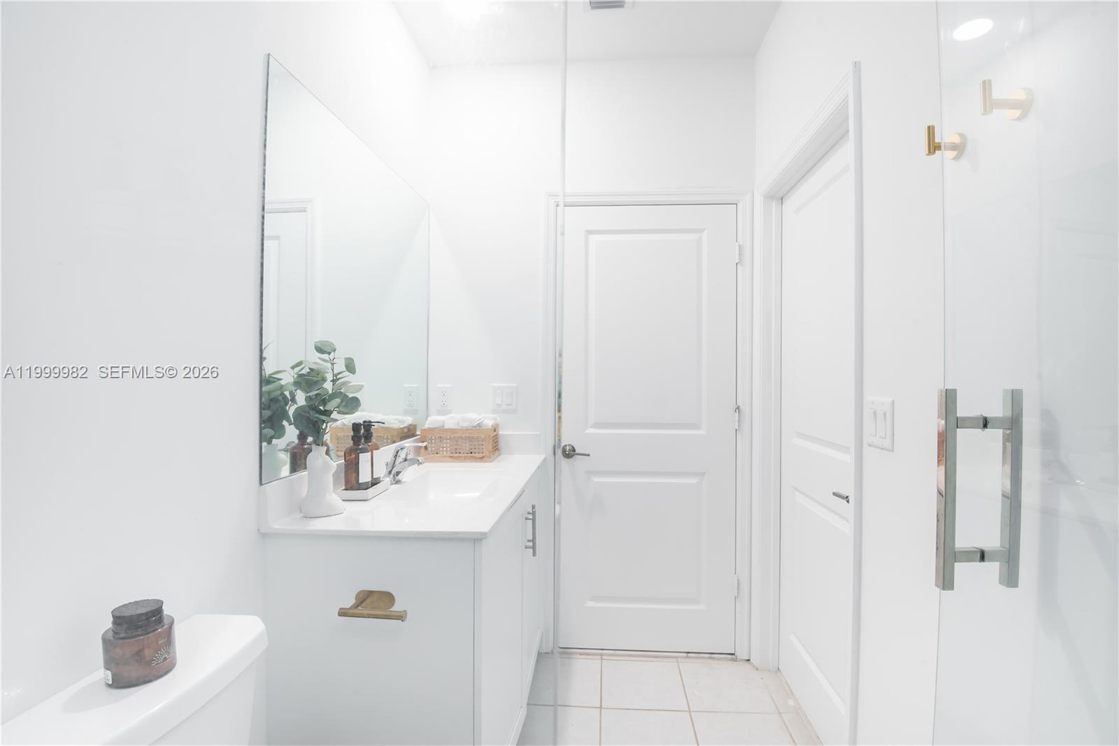 9949 Southwest 228th Terrace Miami, FL 33190 - Photo 10 of 40 a bathroom with a sink and vanity