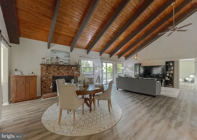 a view of a dining room with furniture and a chandelier