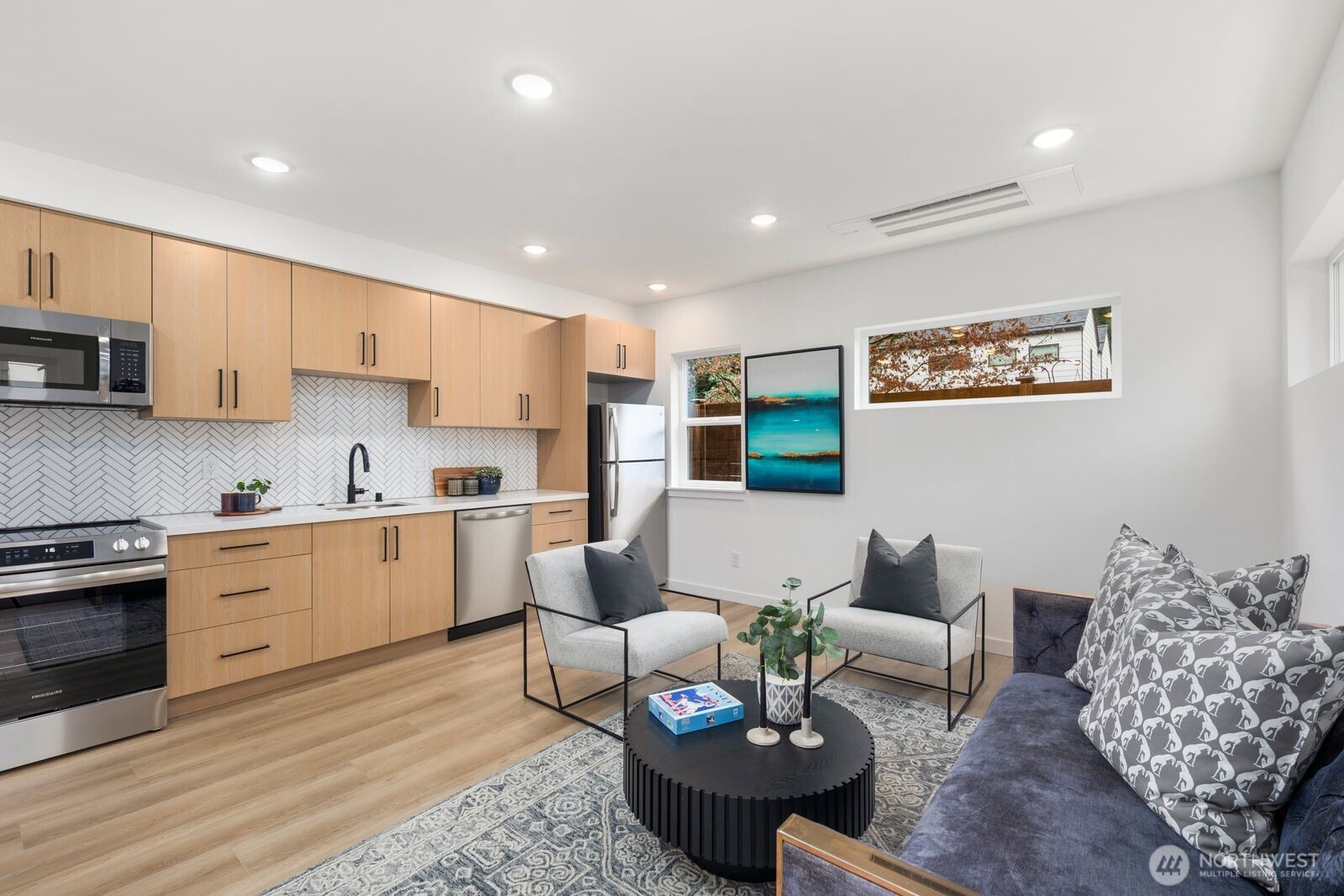 806 South Rose Street Seattle, WA 98108 - Photo 6 of 20 a living room with furniture kitchen view and a wooden floor