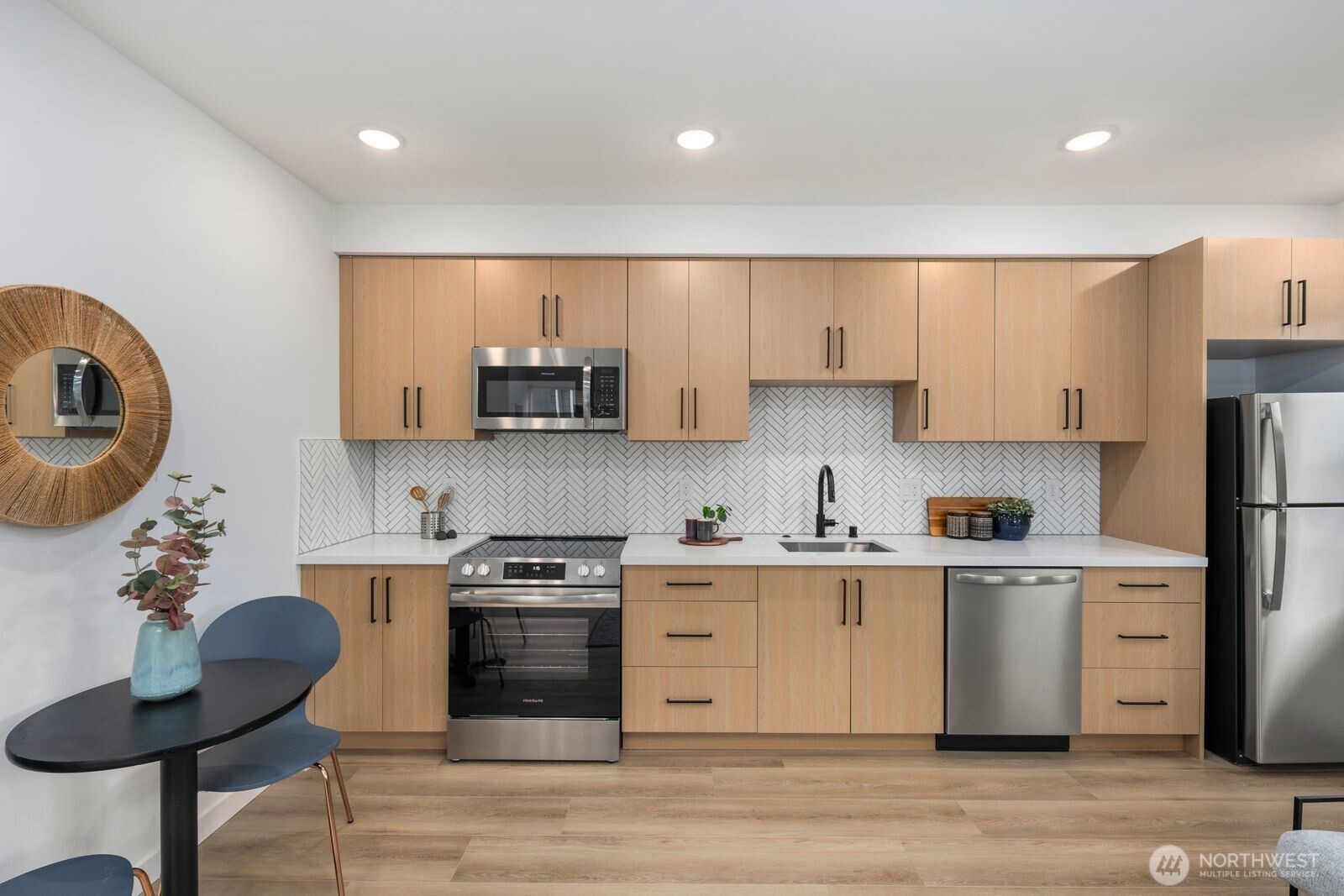 806 South Rose Street Seattle, WA 98108 - Photo 9 of 20 a kitchen with stainless steel appliances granite countertop a stove a sink dishwasher and a refrigerator with wooden floor