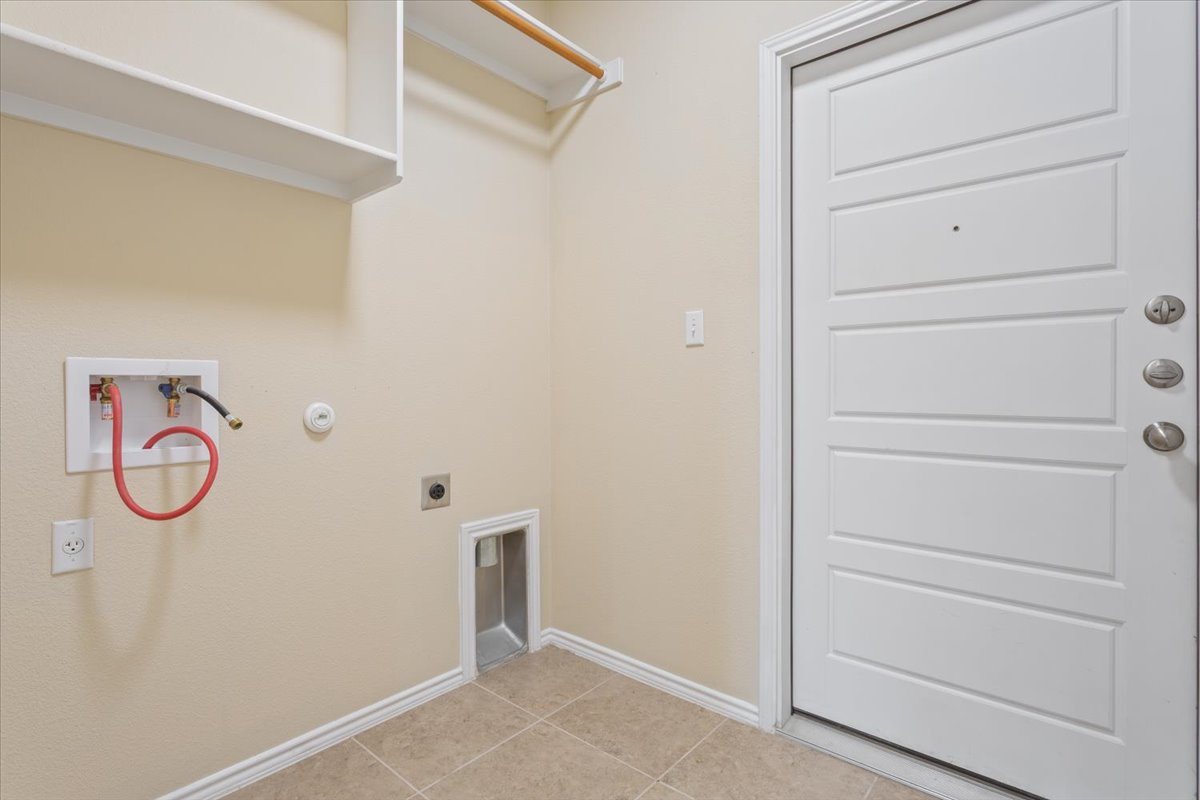 1024 Chad Loop Round Rock, TX 78665 - Photo 25 of 29 Laundry room featuring gas dryer hookup, hookup for a washing machine, electric dryer hookup, and light tile patterned flooring