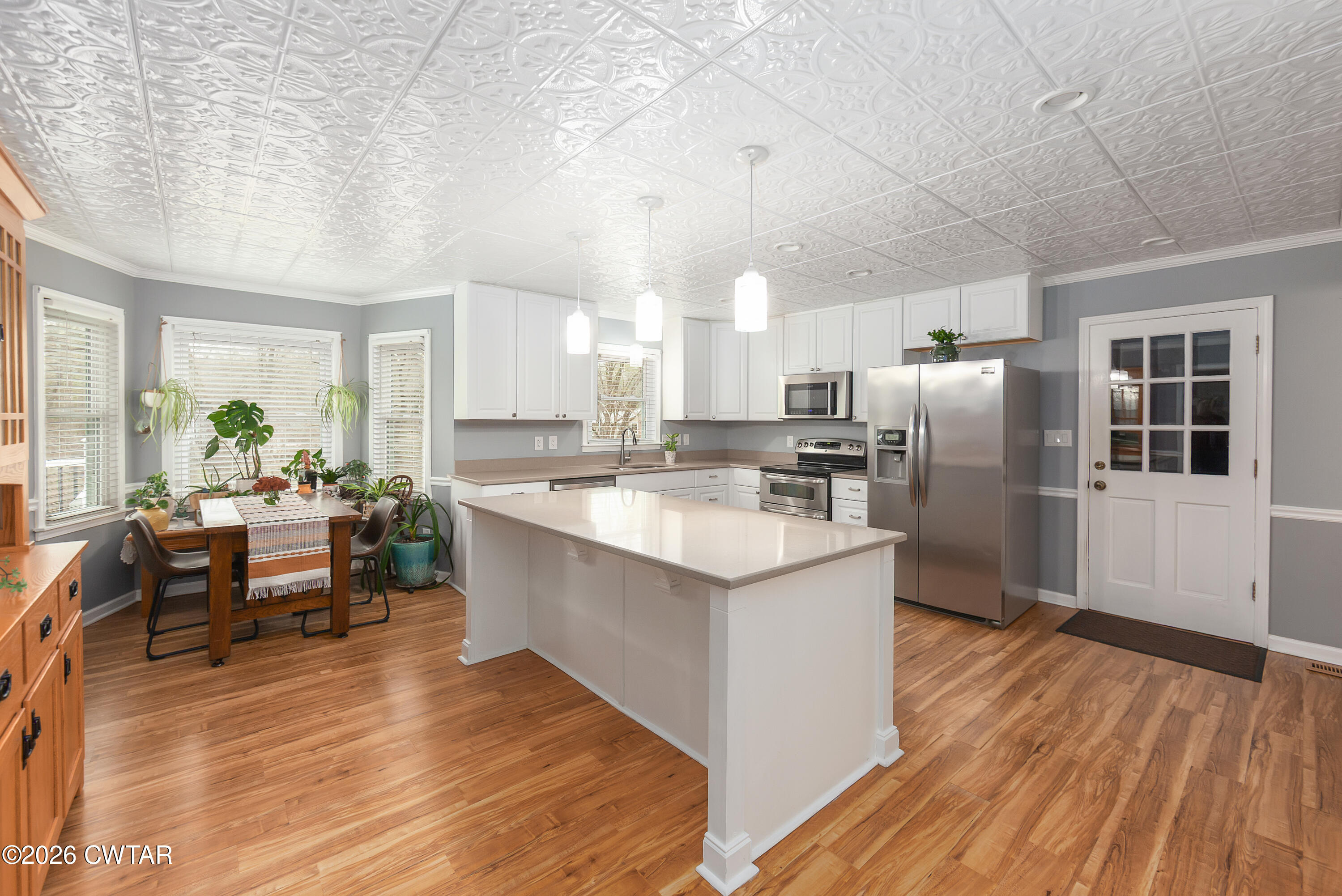 359 Old Bells Road Jackson, TN 38305 - Photo 11 of 40 a kitchen with stainless steel appliances granite countertop a sink stove and wooden floor
