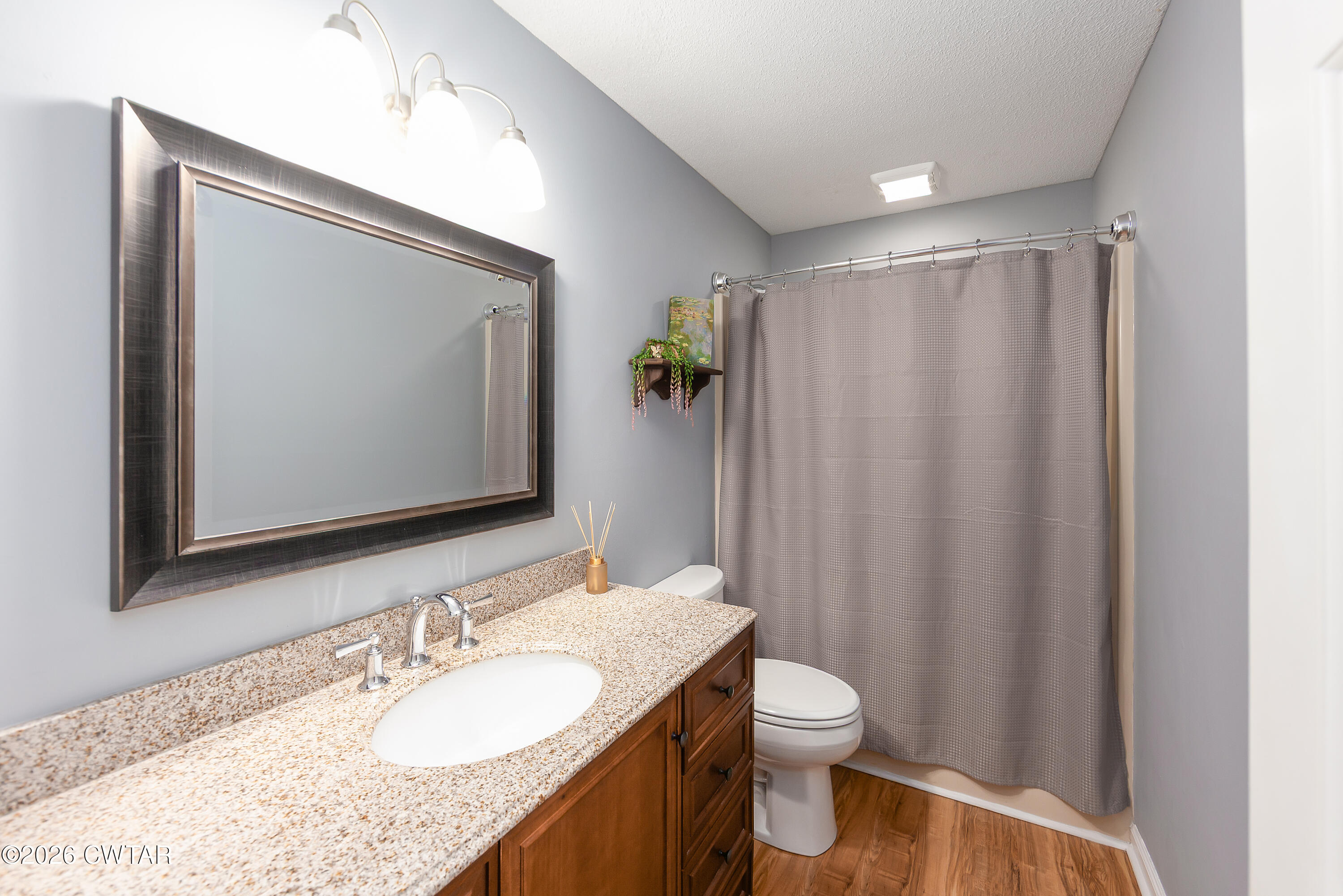 359 Old Bells Road Jackson, TN 38305 - Photo 17 of 40 a bathroom with a granite countertop sink toilet and mirror