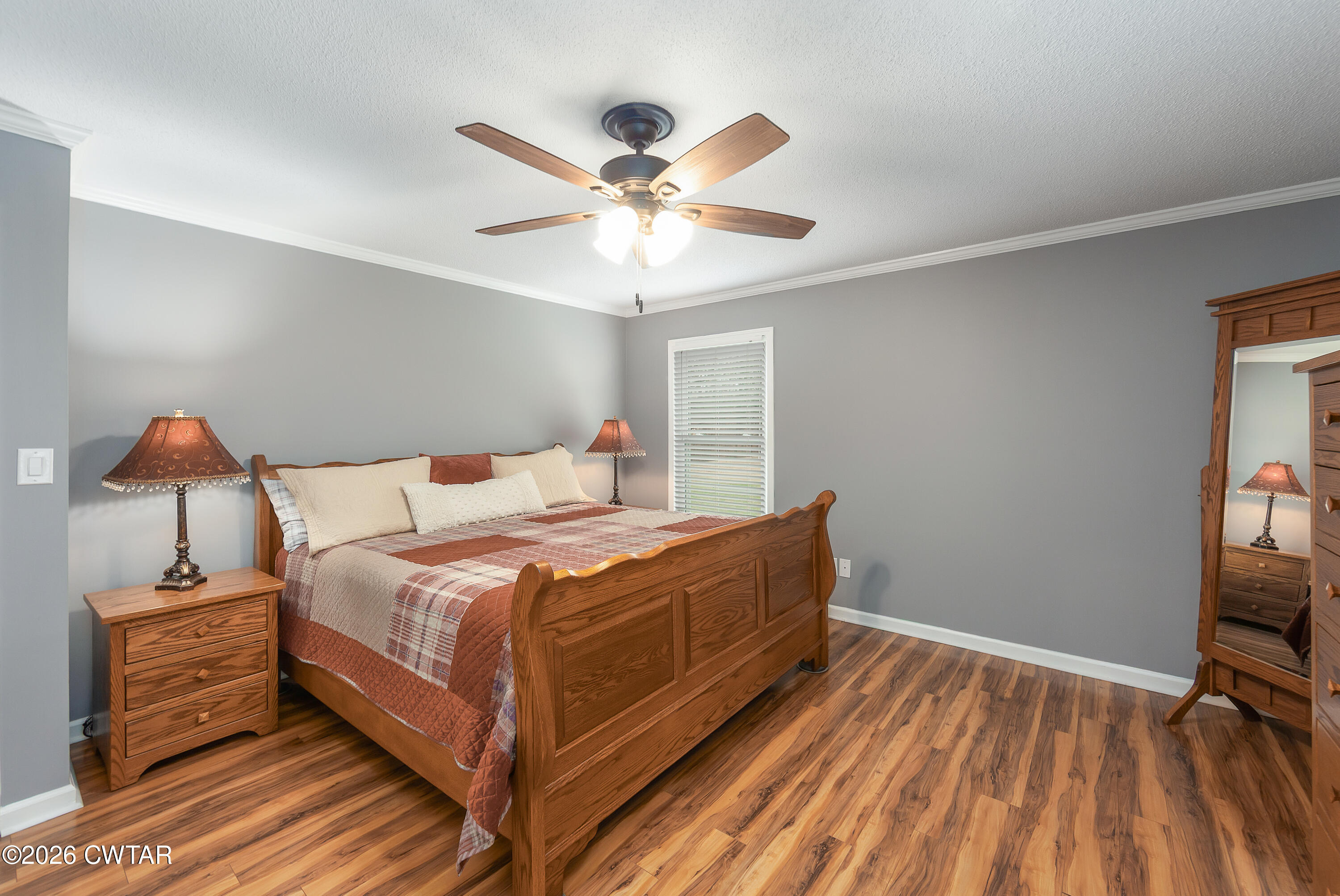 359 Old Bells Road Jackson, TN 38305 - Photo 19 of 40 a bedroom with a bed and a chandelier