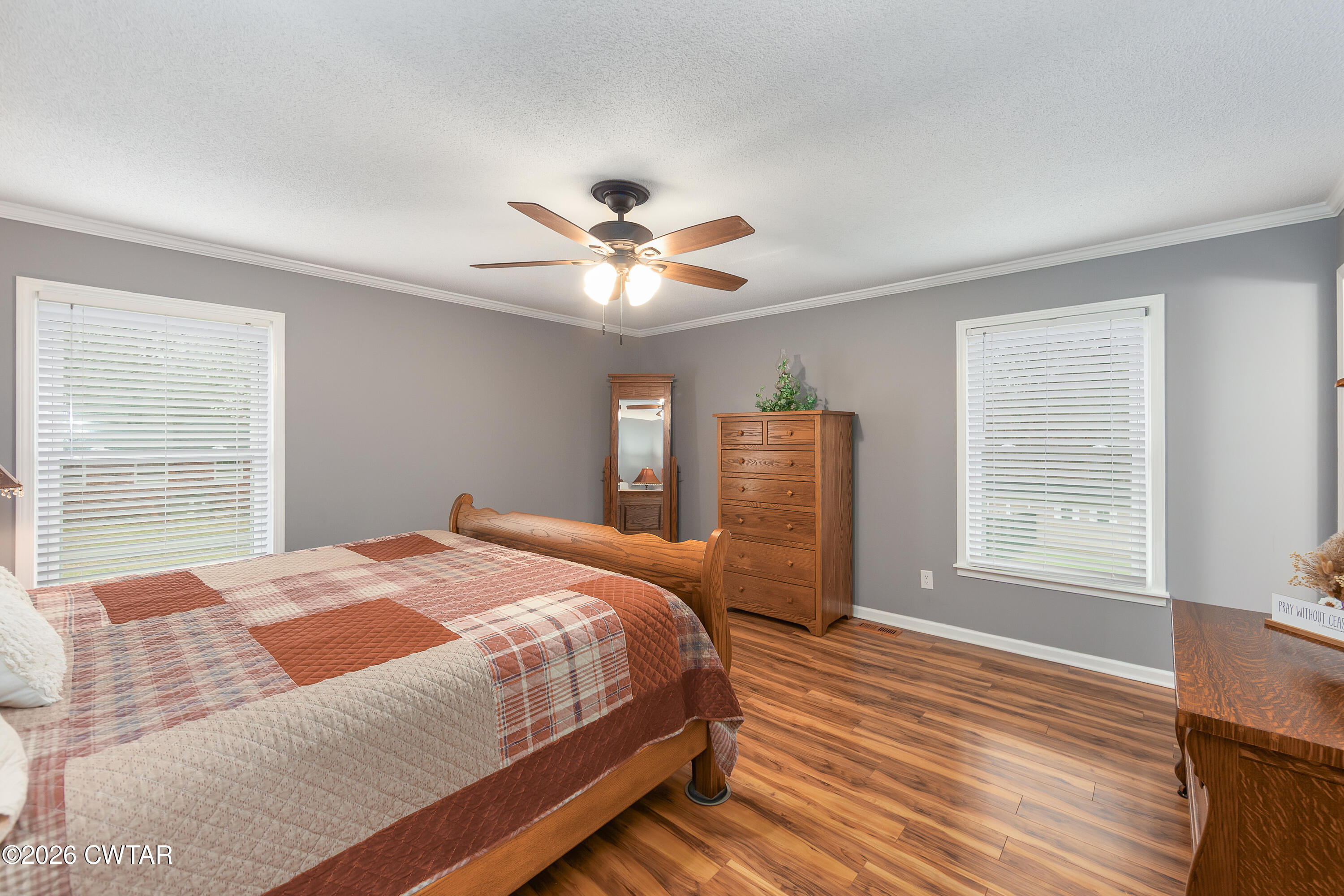 359 Old Bells Road Jackson, TN 38305 - Photo 20 of 40 a bedroom with a large bed a chandelier and a window