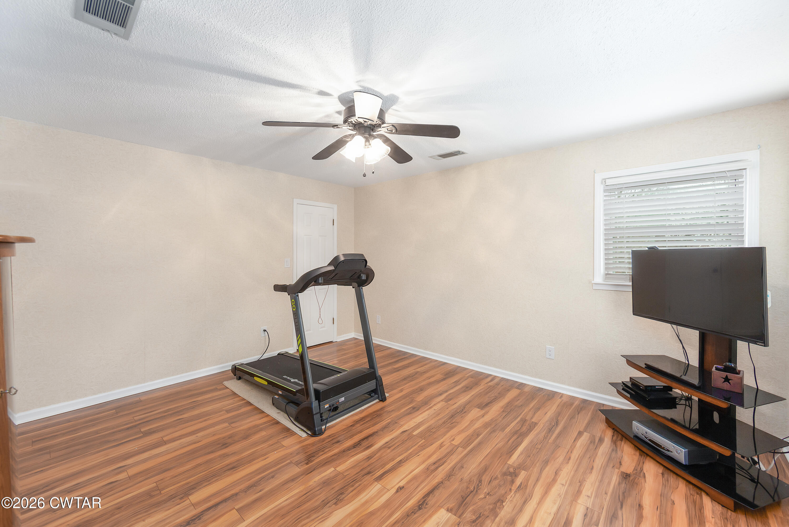 359 Old Bells Road Jackson, TN 38305 - Photo 23 of 40 a room with gym equipment and wooden floor