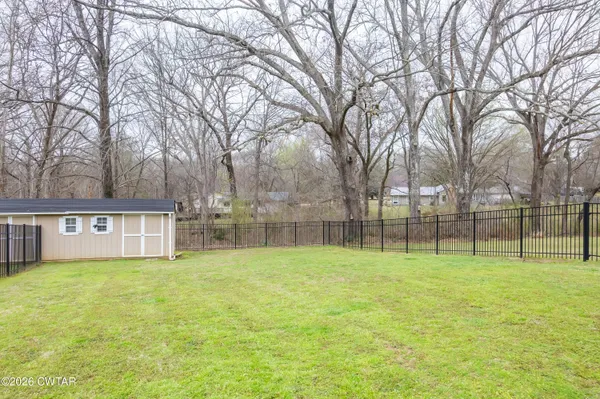 a view of outdoor space with a garden and trees