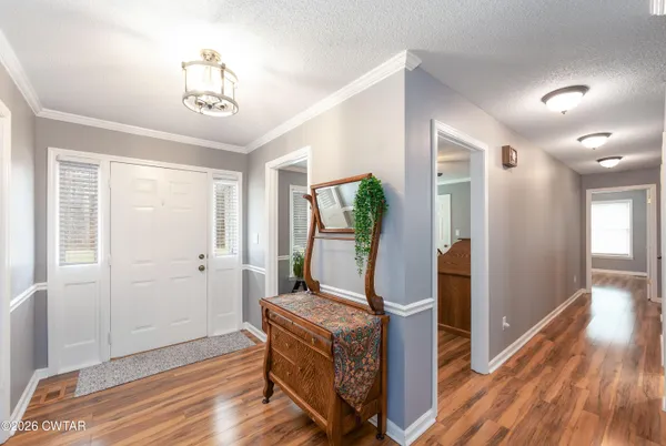 a room with wooden floor and windows