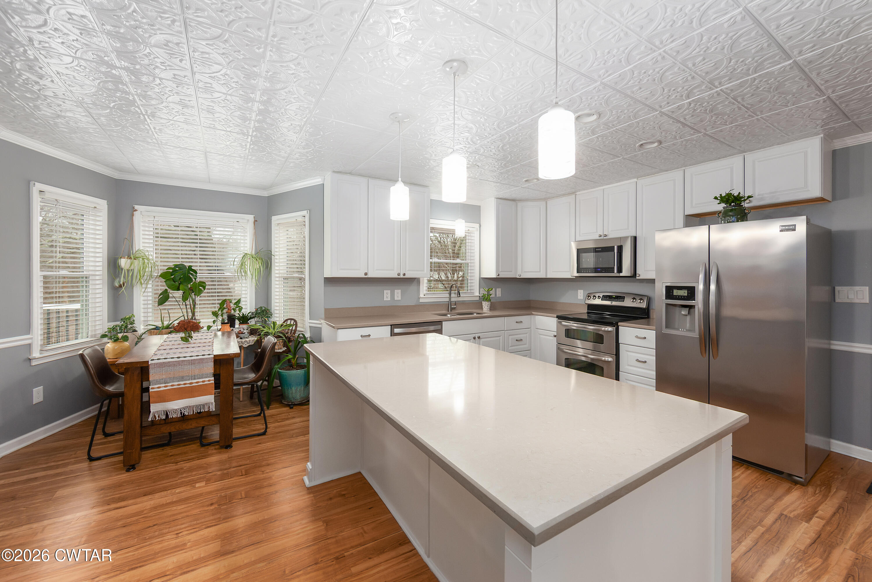 359 Old Bells Road Jackson, TN 38305 - Photo 7 of 40 a large kitchen with kitchen island a large counter top space a sink stainless steel appliances and cabinets