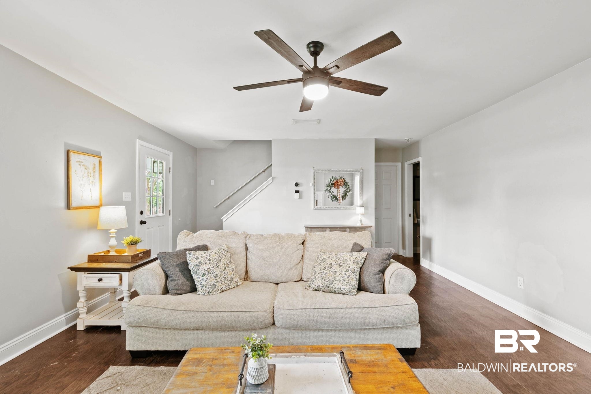 22810 High Ridge Road Fairhope, AL 36532 - Photo 22 of 78 Spacious living area featuring wood-finish flooring, a ceiling fan with integrated lighting, and a white interior door with glass panes