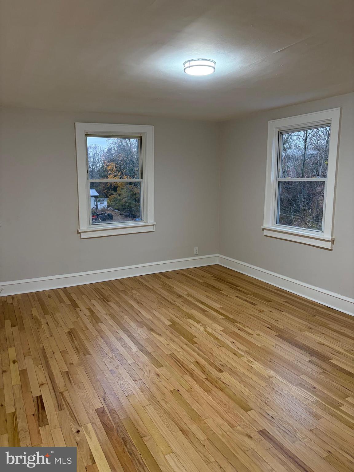 175 9th Street Salem, NJ 08079 - Photo 17 of 24 a view of an empty room with wooden floor and a window