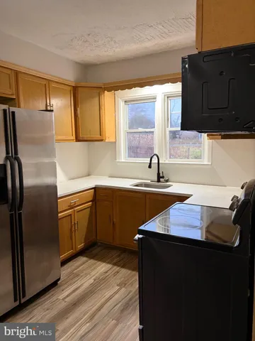 a kitchen with granite countertop a sink and cabinets