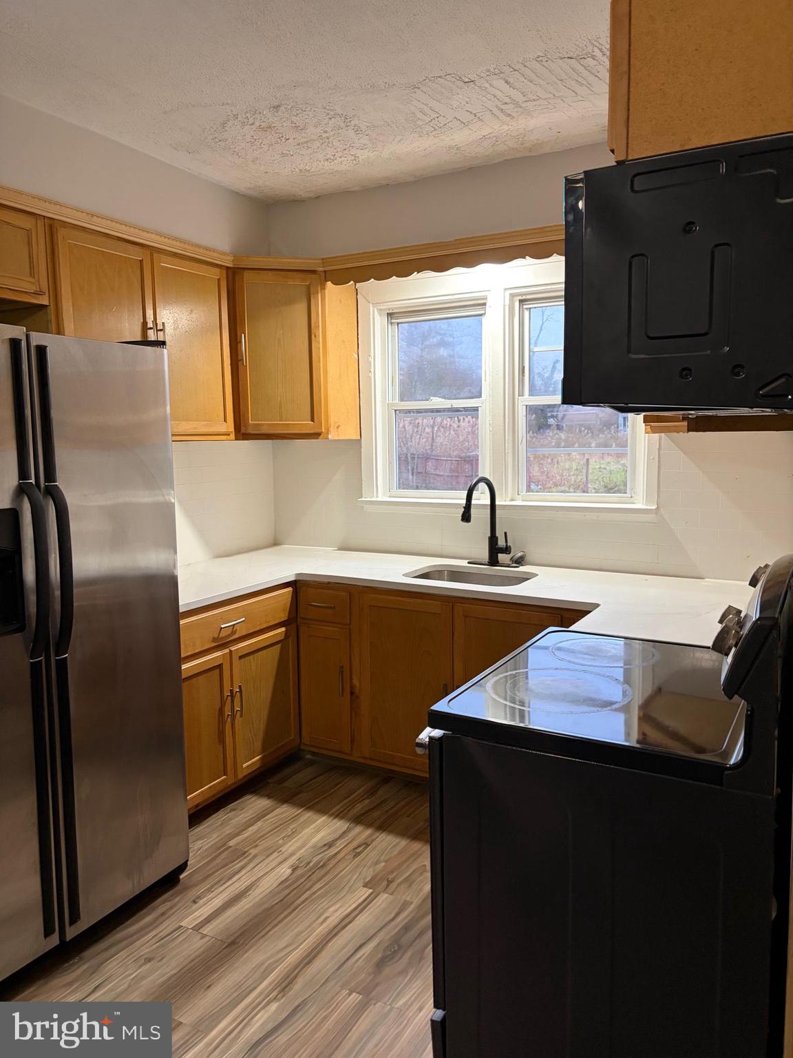 175 9th Street Salem, NJ 08079 - Photo 10 of 24 a kitchen with granite countertop a sink and cabinets