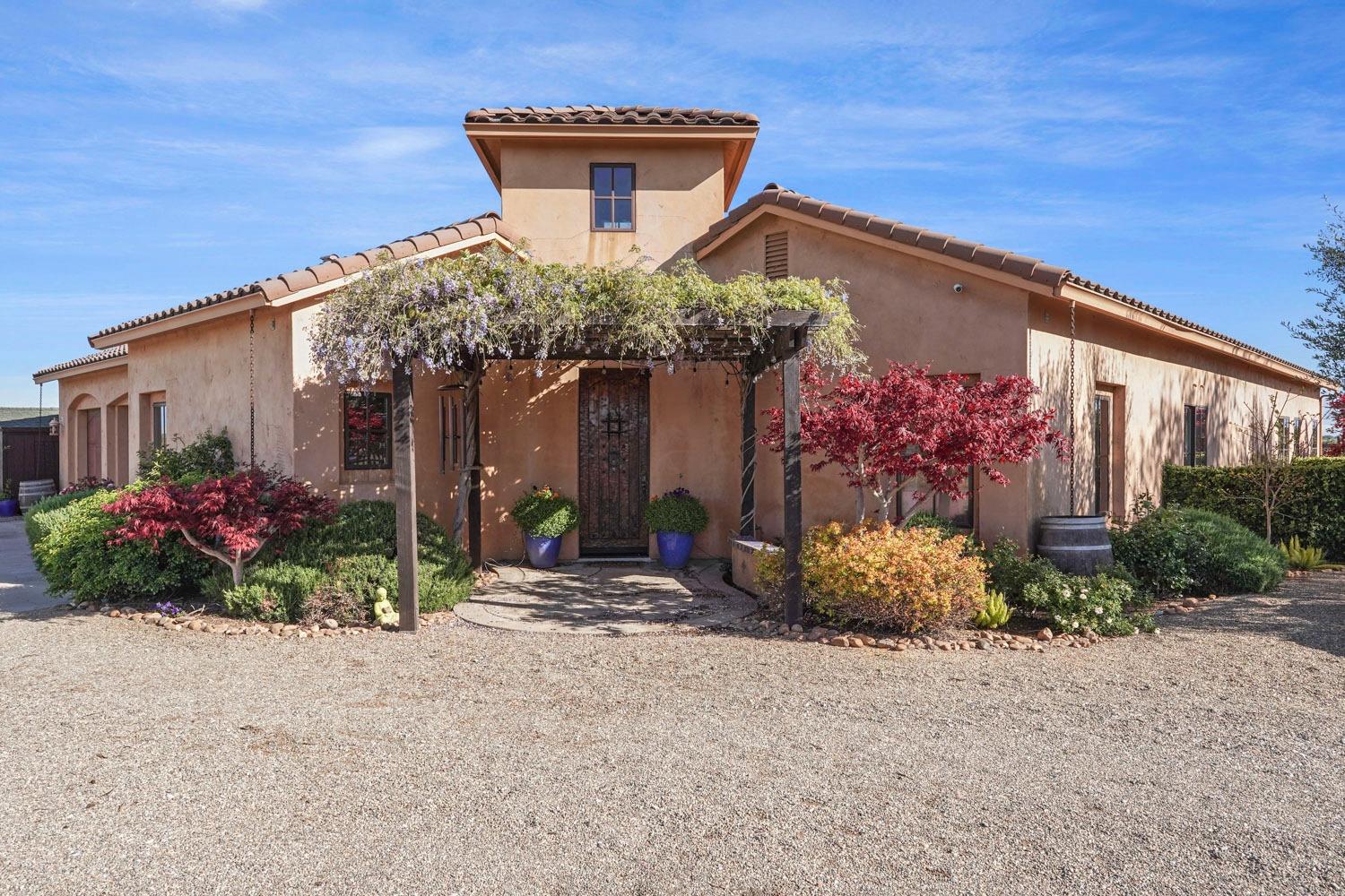 19330 East Stampede Road Lodi, CA 95240 - Photo 1 of 1 a front view of a house with a yard and potted plants
