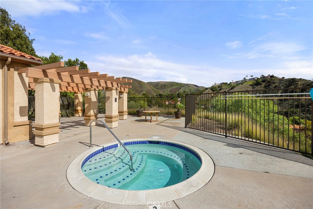 5370 Silver Canyon Road, Unit 7E Yorba Linda, CA 92887 - Photo 31 of 33 a view of a swimming pool with a patio and a garden