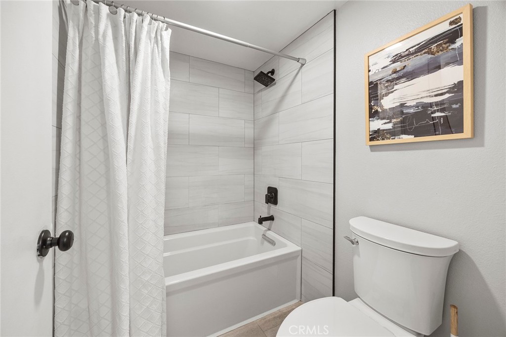 5370 Silver Canyon Road, Unit 7E Yorba Linda, CA 92887 - Photo 8 of 33 a white toilet sitting next to a bath tub