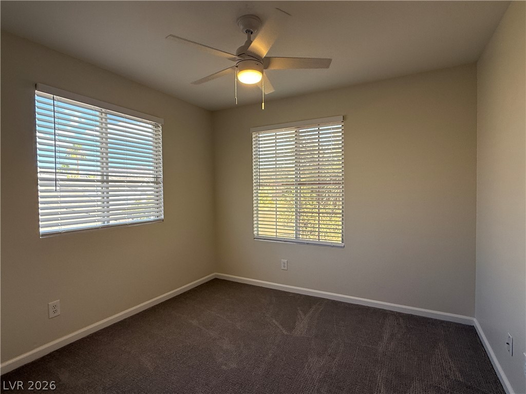 1908 Thunder Ridge Circle Henderson, NV 89012 - Photo 22 of 28 A well-lit room offers ample natural light and a practical ceiling fan for comfort.