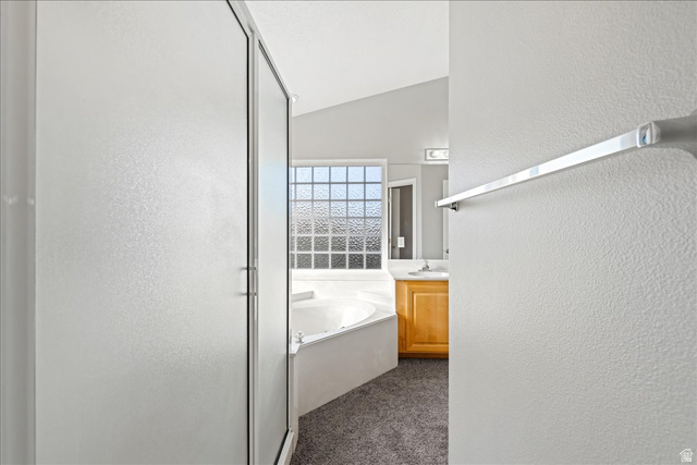 7 Reflection Way St. George, UT 84770 - Photo 46 of 54 Bathroom featuring a textured wall, vanity, a stall shower, a bath, and dark colored carpet