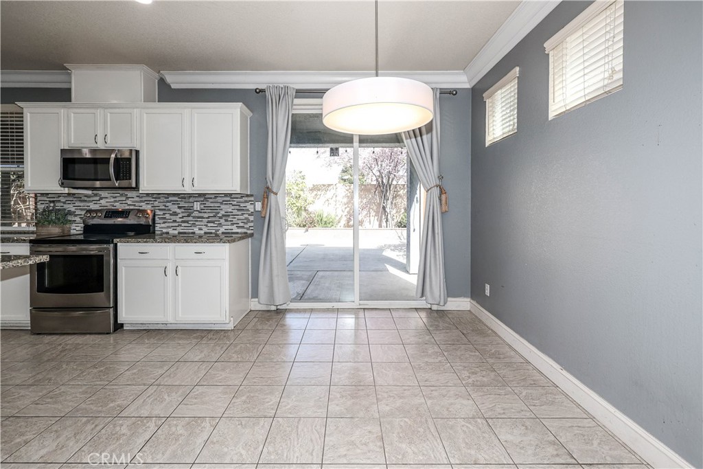 1367 Esplanade Drive Merced, CA 95348 - Photo 17 of 51 a view of a kitchen with microwave and stove
